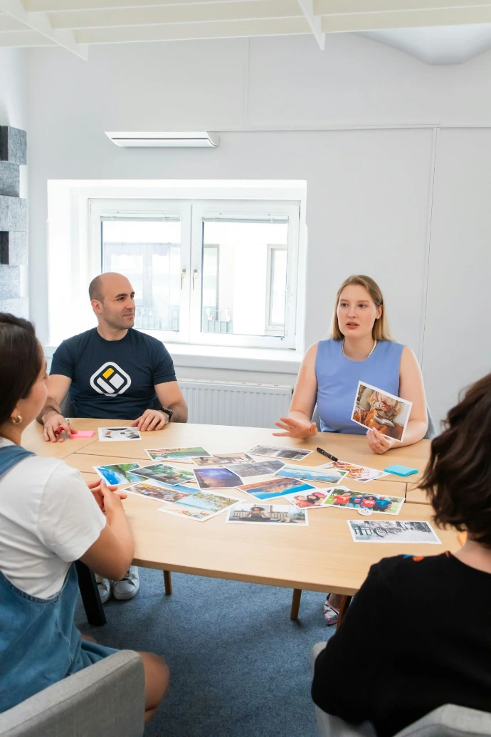 a group of people sitting around a wooden table